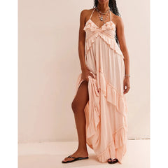 Pale pink ruffled halter maxi dress with a high leg slit.