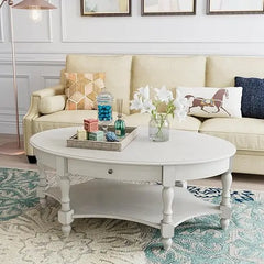 Living room with a beige sofa, decorative pillows, and a white coffee table.