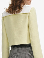 Light yellow jacket with white collar worn by a person