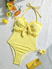 Yellow textured one-piece swimsuit with ruffled trim and halter neck