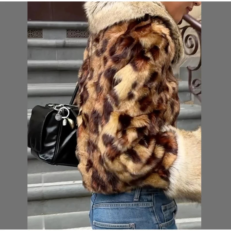 Person wearing a fur coat with a leopard print pattern, holding a black handbag.