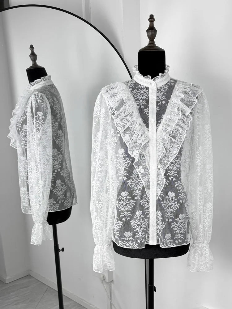 White lace blouse on a mannequin against a white background