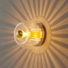 Close-up of a glass wall sconce chandelier, showcasing the intricate design and sparkling glass accents. A