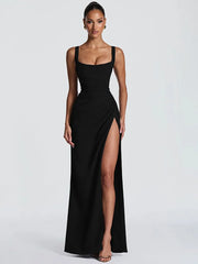 Woman wearing a black sleeveless gown with a high slit on a white background