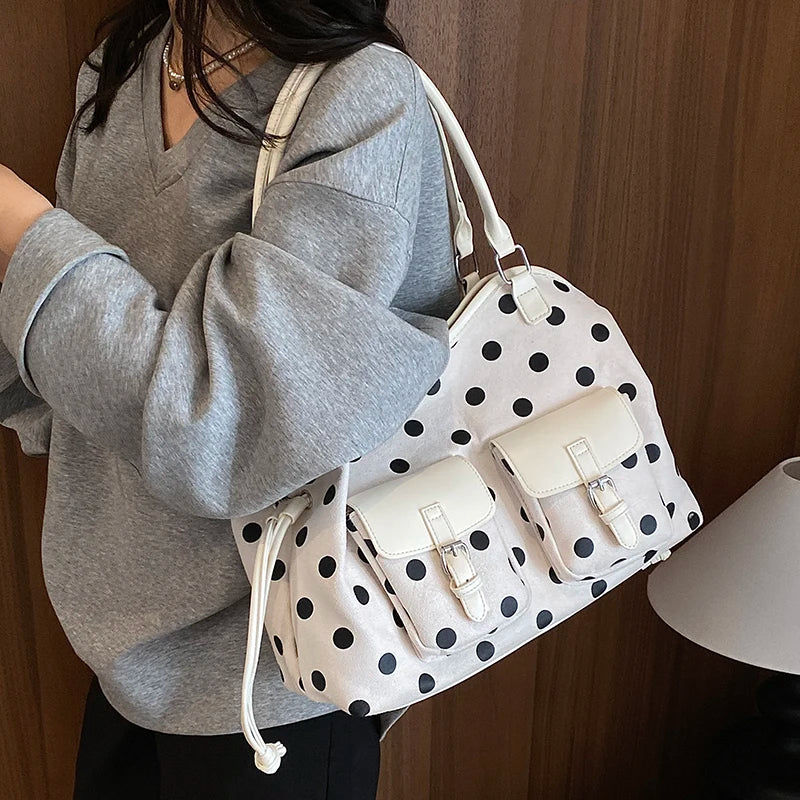 White polka dot faux leather tote bag with dual front pockets