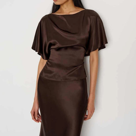 Brown satin blouse with cape-like sleeves on a white background