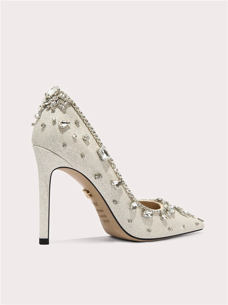 Sparkly high-heeled shoe with crystal embellishments on a light gray background