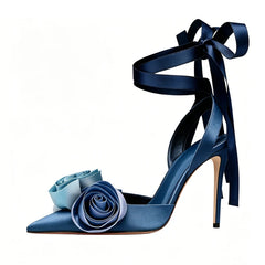 Blue satin stiletto sandals with gradient rose embellishments and ankle tie.