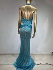 Women's sequin halter dress with adjustable straps.