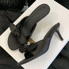 Black satin bow slide heels with thin heel