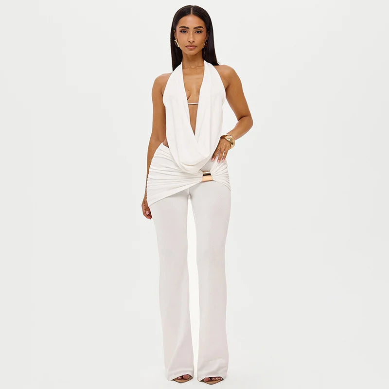 Woman wearing a white outfit on a plain background