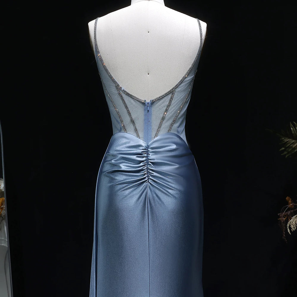 Blue evening gown with intricate back design on a black background