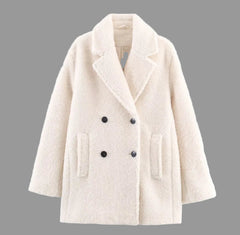 Beige coat with black buttons on a white background