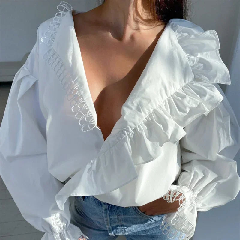 White blouse with ruffled sleeves and lace details worn by a person.