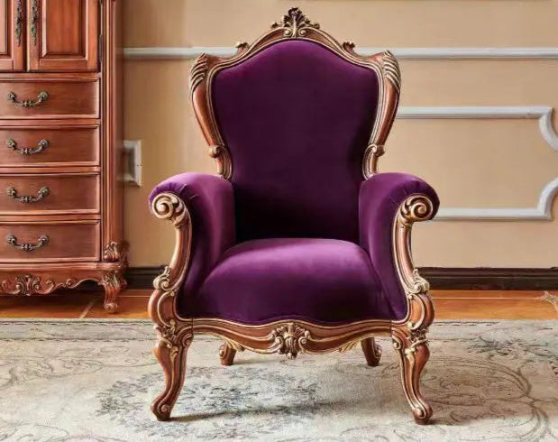 Purple armchair with gold accents in a room with wooden furniture.