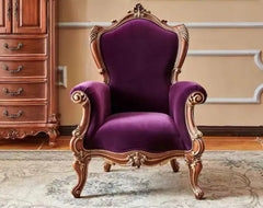 Purple armchair with gold accents in a room with wooden furniture.