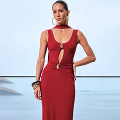 Woman wearing a red dress with a cutout design against a light blue background