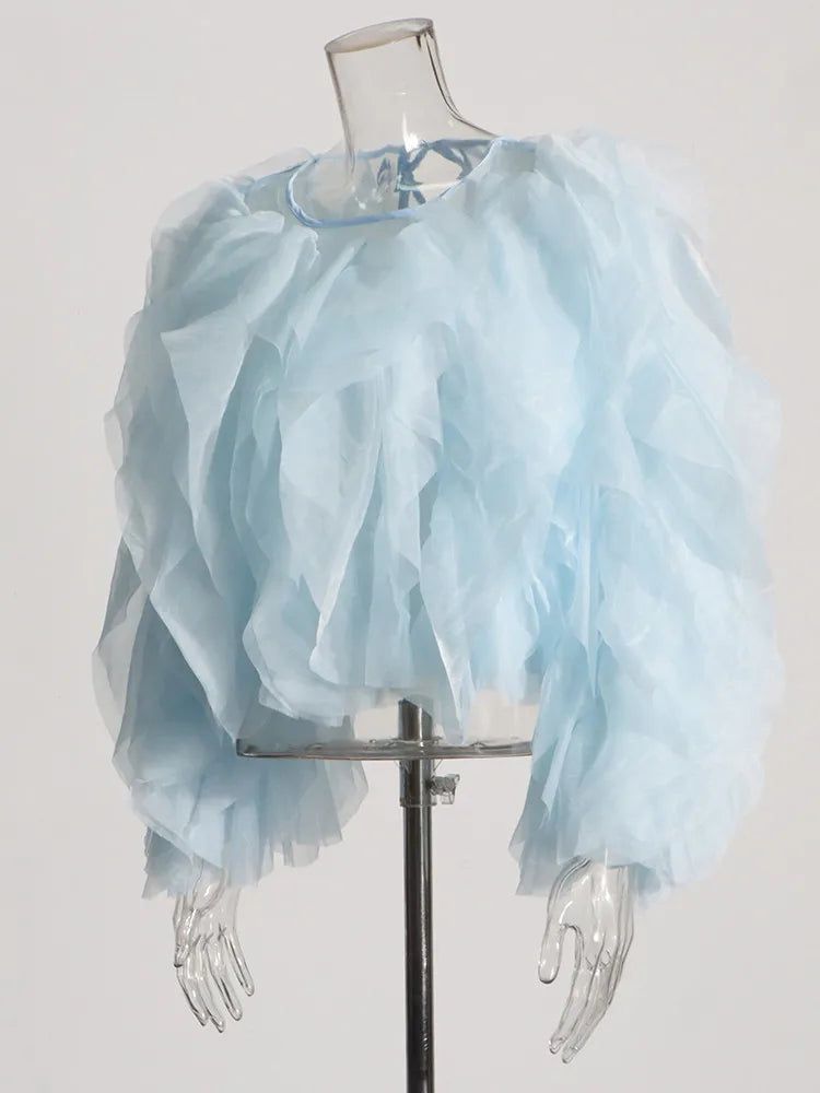 Light blue ruffled top on a mannequin against a white background