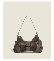 Brown handbag with metal buckles on a beige background