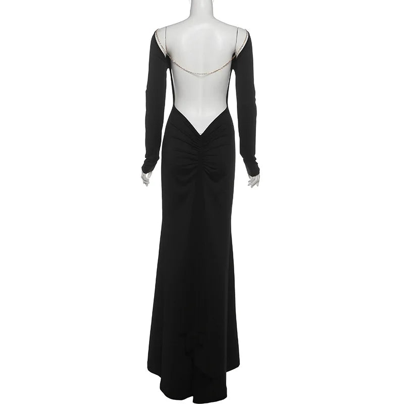 Black evening gown with open back on a mannequin against a white background