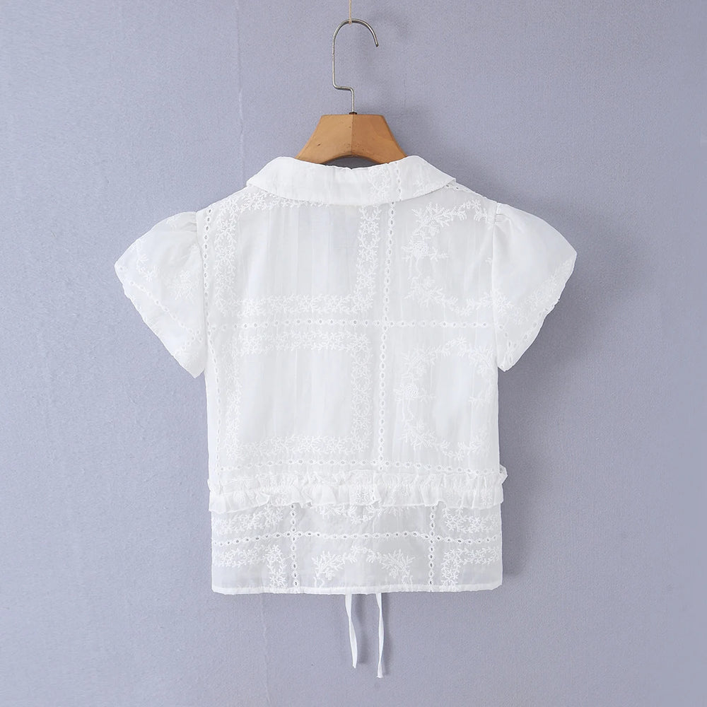 Back view of white embroidered puff sleeve crop top