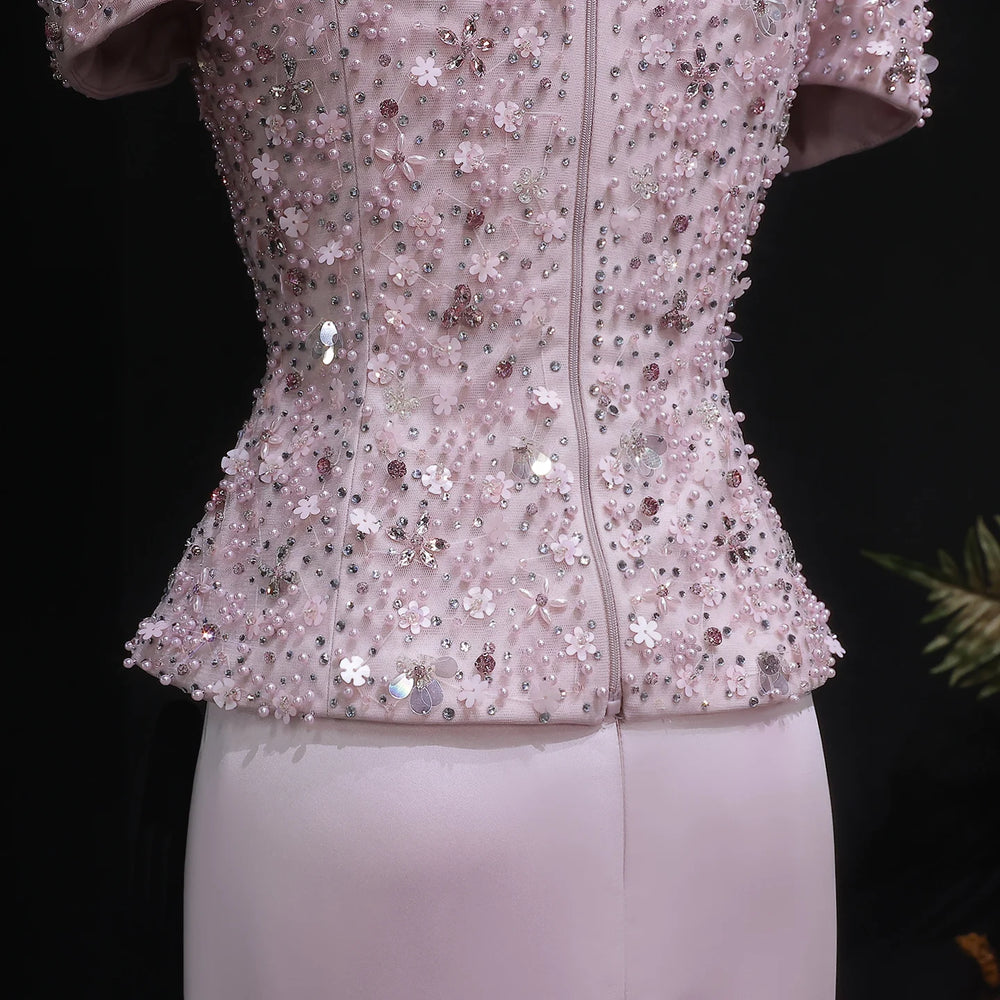 Pink sequin jacket on a mannequin against a black background
