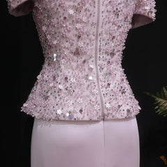 Pink sequin jacket on a mannequin against a black background