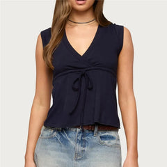 Sleeveless wrap front top with tie waist and peplum hem