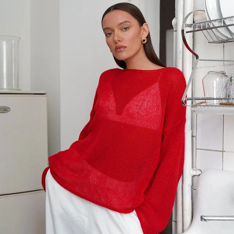 A woman wearing a stylish transparent  Red knit sweater with long sleeves, perfect for fall layering. Golden Atelier 1