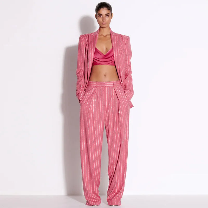A woman wearing a pink striped suit