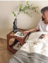 A minimalist Scandinavian corner table crafted from solid wood, placed in a cozy living room corner. C