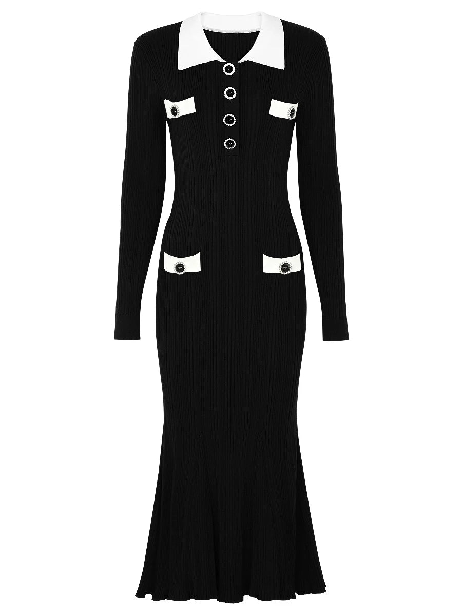 Black dress with white collar and buttons on a white background