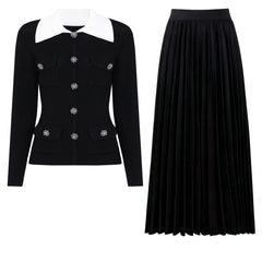 Black knit cardigan with white collar and jeweled buttons paired with a black pleated midi skirt.