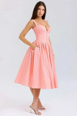 Woman wearing a pink dress on a white background