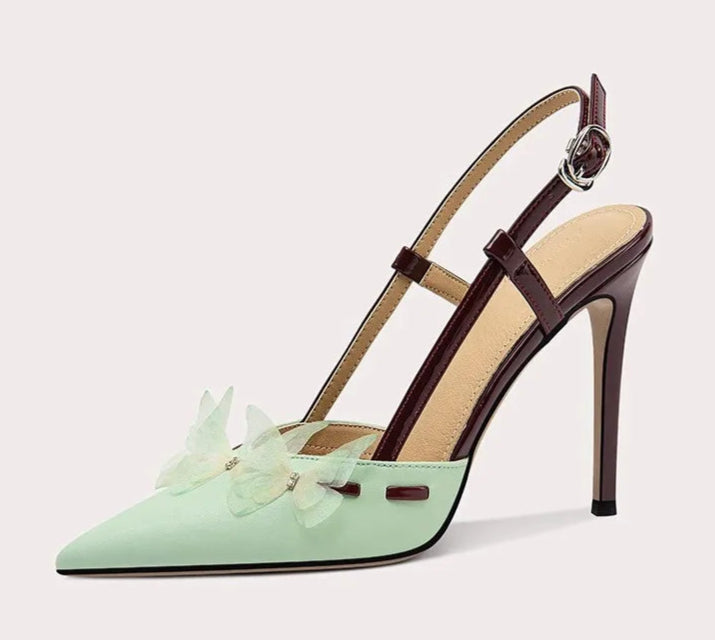 Mint green high-heeled shoe with a brown strap on a white background