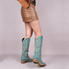 Rear view of model in embroidery pointed toe side zip boots