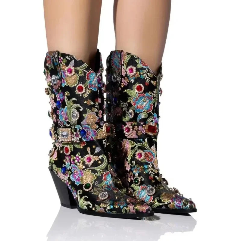Black embroidered pointed toe boots with rhinestones and a block heel.