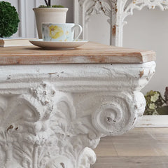 Unique  side table with architectural design placed in classical-themed space