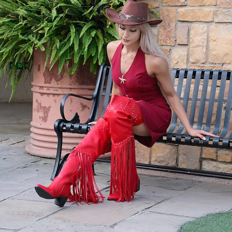 Fringed pointed toe heeled boots styled with dress