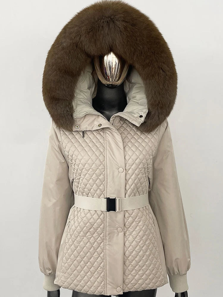 Beige quilted jacket with a large brown fur hood on a mannequin against a white background