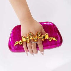 Sculptural wave handle clutch bag with pink acrylic exterior