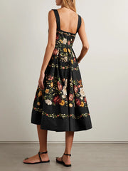 Back view of a black floral print square neck sleeveless A-line midi dress with a gathered hem.