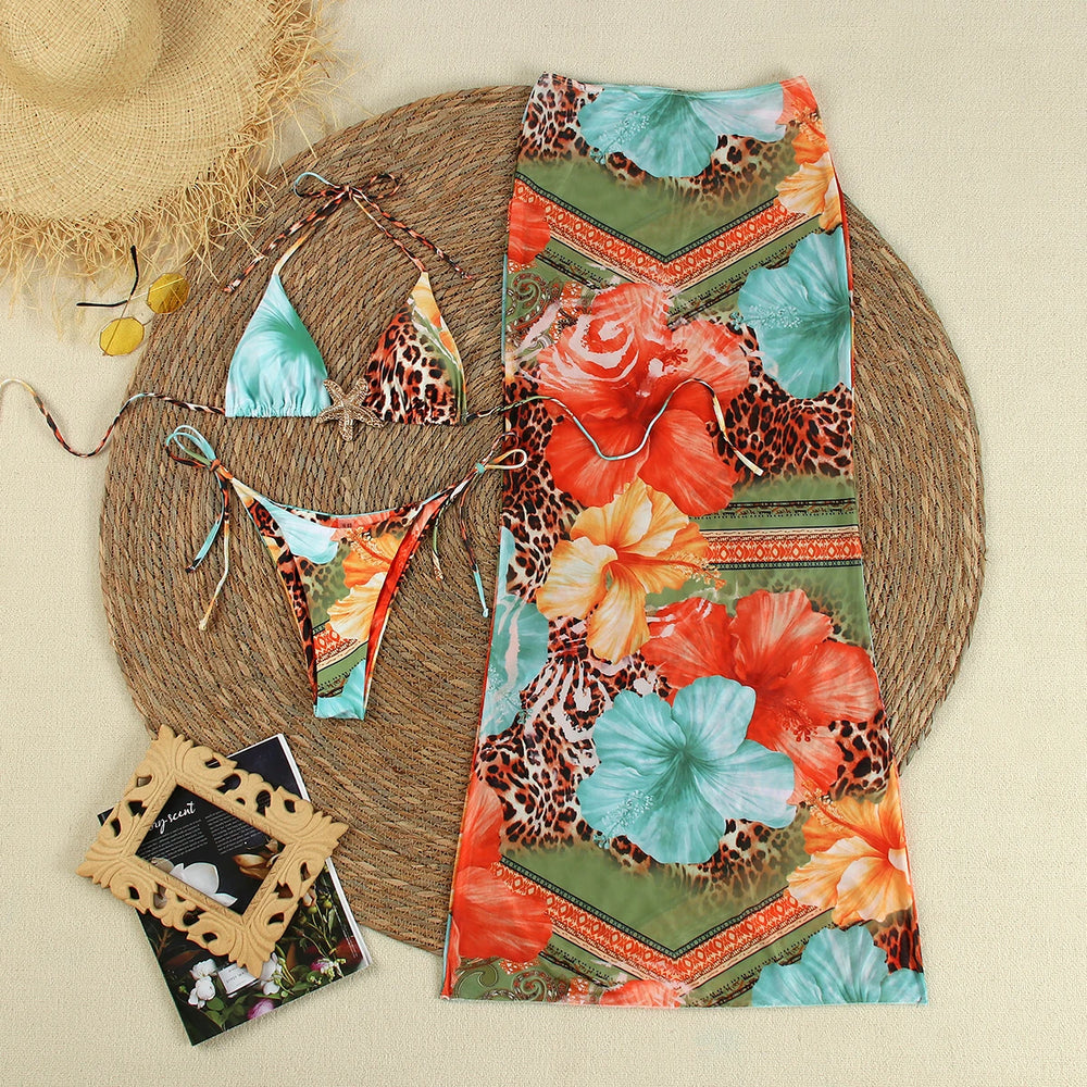 Flat lay of a bikini set with a matching long cover-up skirt.