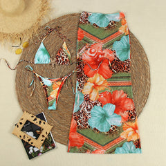 Flat lay of a bikini set with a matching long cover-up skirt.