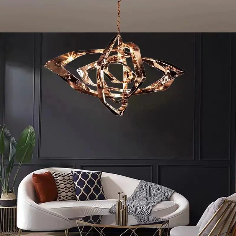 Modern copper chain design chandelier with intertwining sculptural loops above a contemporary living room sofa
