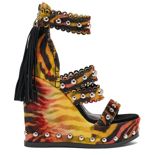 Tiger print wedge platform sandals with metallic studs and black tassels
