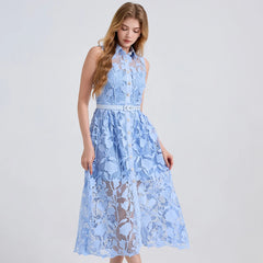 Woman wearing a light blue lace dress on a white background