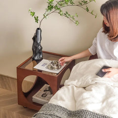 A minimalist Scandinavian corner table crafted from solid wood, placed in a cozy living room corner. A