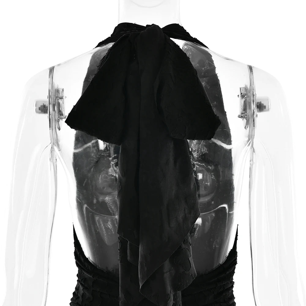 Black top with sheer overlay on a mannequin against a white background