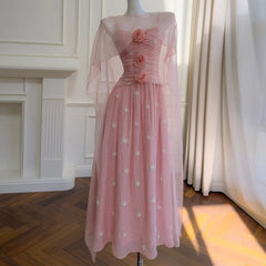 Pink embroidered midi dress with rose embellishments and sheer overlay on a mannequin